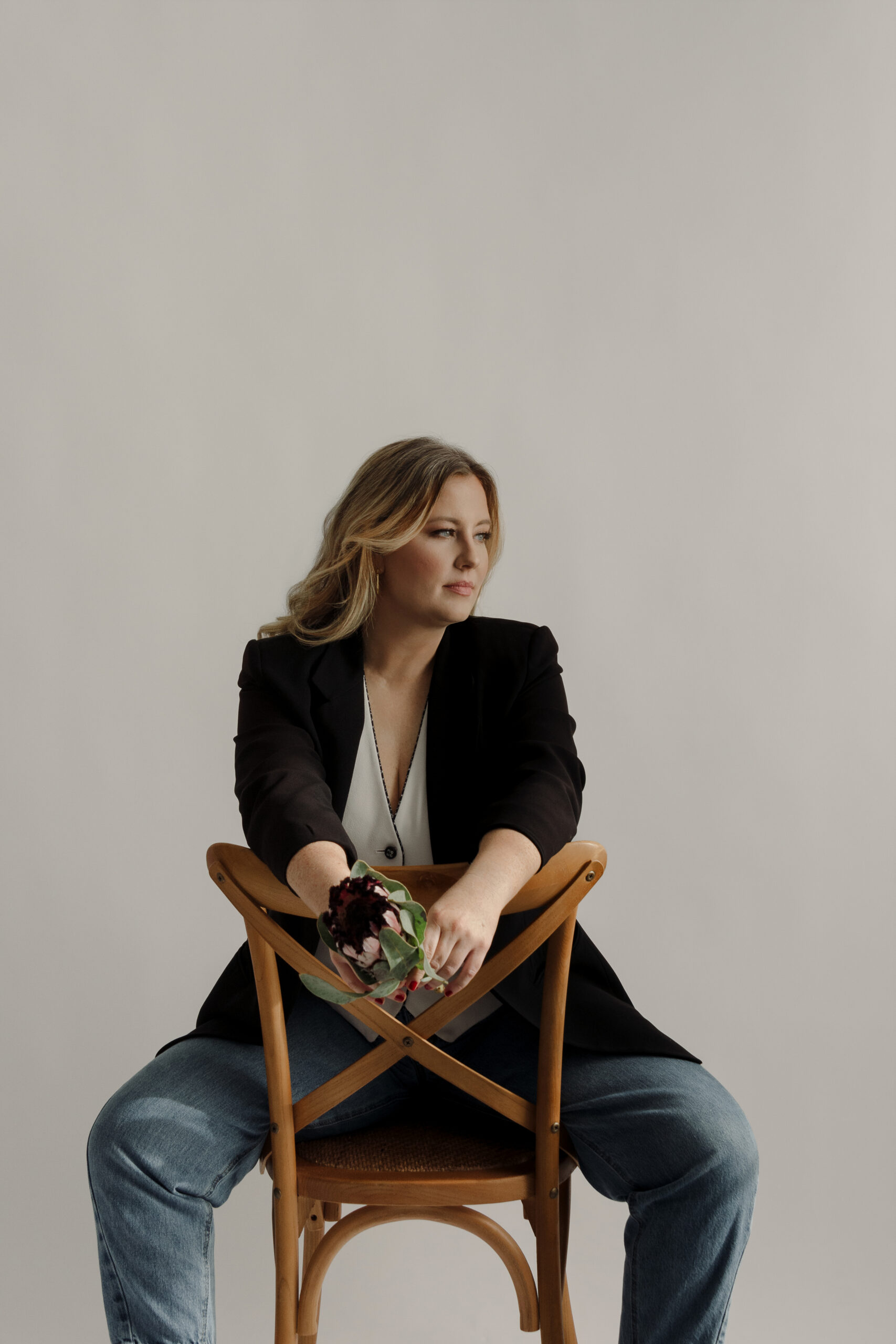 Branding portrait of Devin, founder of Candle Light Gatherings, seated in studio during her brand session refresh.